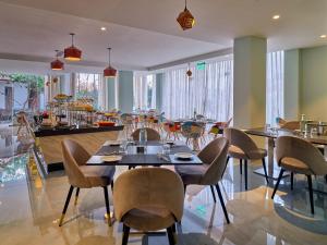 a dining room with tables and chairs in a restaurant at Zone Connect by The Park Port Blair in Port Blair