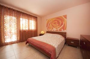a bedroom with a bed and a large window at Apartment with pool near Split in Split