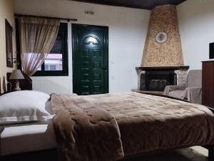 a bedroom with a large bed and a green door at Paradise Studios in Kato Loutraki