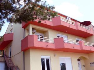 a building with red balconies on top of it at Apartment with pool near Split in Split