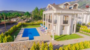 an aerial view of a house with a swimming pool at Silver Sami Villa, Özel Havuzlu, Fethiye, in Fethiye