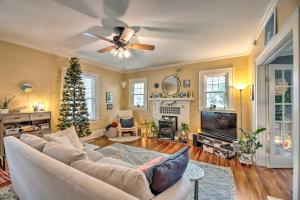 a living room with a couch and a christmas tree at Cozy, Updated Rocky Mt Home by City Lake Park in Rocky Mount