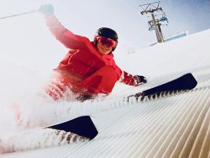 a person is skiing down a snow covered slope at Life is Beautiful - Vacation STAY 94973 in Hachimantai