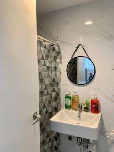 a bathroom with a sink and a mirror at Cebu City Condo Hotel in Meridian with Netflix and WIFI, near Ayala and IT Park U7 09 11 in Cebu City