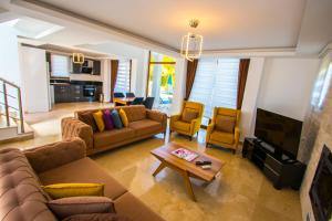 a living room with two couches and a tv at Silver Sami Villa, Özel Havuzlu, Fethiye, in Fethiye +16 photos