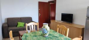 a living room with a table with a vase on it at Mare e Coccole in Caprioli