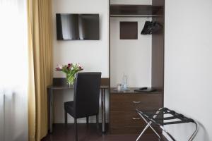 a room with a desk and a chair and a table at Hotel Kiez Pension Berlin in Berlin