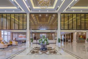 a lobby of a hotel with a fountain in the middle at Meliá Vinpearl Hai Phong Rivera in Hai Phong +73 photos