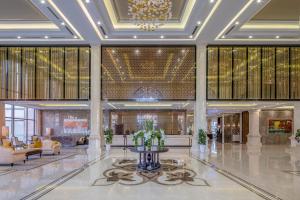a lobby of a hotel with a fountain in the middle at Meliá Vinpearl Hai Phong Rivera in Hai Phong
