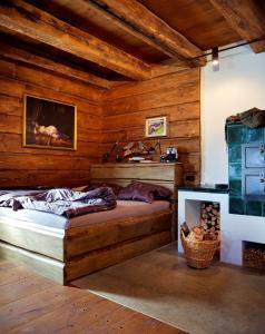 a bedroom with a bed in a room with wooden walls at Lovecká chata VRŠAVA in Koryčany