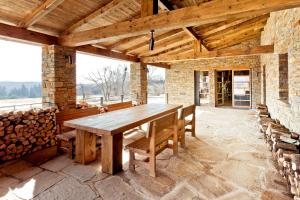 a wooden table and benches on a patio at Lovecká chata VRŠAVA in Koryčany