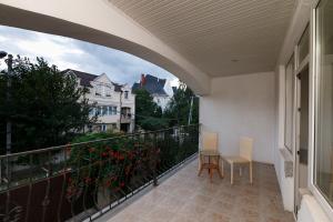 a balcony with two chairs and a table on it at ezio in Chişinău