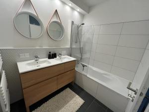 a bathroom with a sink and a tub and a mirror at Fuchs-Fichte in Bad Harzburg +10 photos