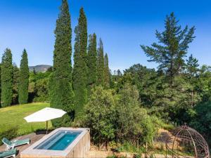 a swimming pool in a garden with trees at Devon Castle Forest Lodge in Stellenbosch