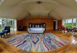 a large room with a large rug on a wooden floor at Tenzinling Luxury Villa Tents in Paro