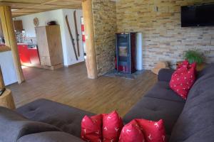 a living room with a couch with red pillows at Ferienwohnung Bergkristall in Oberstdorf