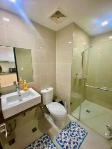 a bathroom with a toilet and a shower and a sink at AFFORDABLE StayCation EASTWOOD CITY in Manila