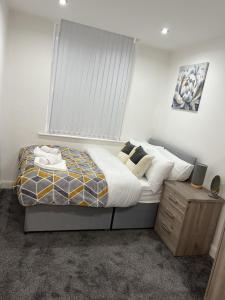 a bedroom with a large bed with a window at Urban Retreat - Bradford Apartment Gem in Bradford