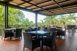 un restaurante con mesas y sillas en un patio en San Lameer Villa 3120 - 3 Bedroom Classic - 6 pax - San Lameer Rental Agency, en Southbroom