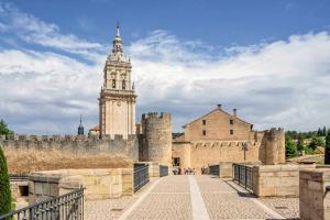 a view of a castle with a clock tower at Hostal - Restaurante La Buena Villa by Vivere Stays in Villalonquéjar