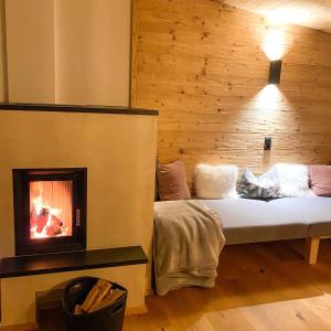 a room with a bed with a fireplace at Chalet Tuxer in Achenkirch