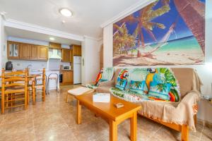 a living room with a couch and a table at Apartamento en el Cabo roig in Orihuela