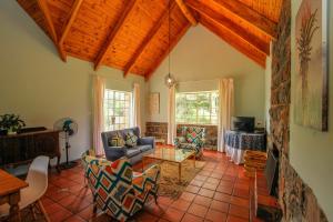 a living room with a couch and a table at Spion Kop Lodge in Winterton