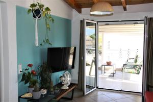 A television and/or entertainment centre at Asteri Apartments Mytikas 2-Bedroom Penthouse 360 Views