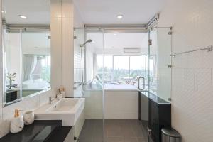 a bathroom with a sink and a glass shower at Sunset Residence Karon Beach in Karon Beach +13 photos