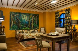 a living room with a couch and a painting on the wall at Kholle House in Zanzibar City
