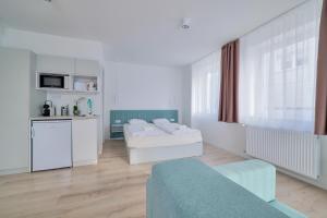 a living room with two beds and a kitchen at Villa Oliver 2 Hévíz in Hévíz