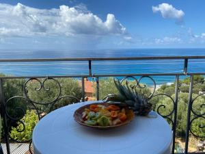 a bowl of fruit sitting on a table on a balcony at Mare e Coccole in Caprioli