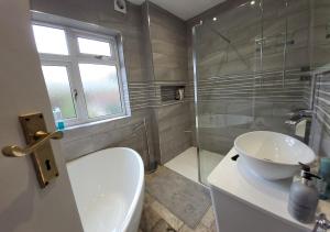 a bathroom with a toilet and a sink and a shower at Quiet Terraced House in Bristol