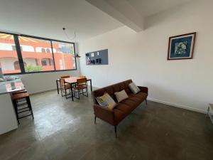 a living room with a couch and a table at Tia Nita Apartamentos in Mindelo