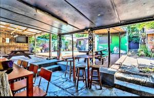 a restaurant with tables and chairs in a room at Tekweni in Durban