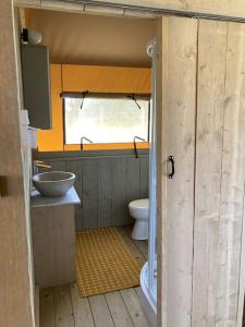 a bathroom with a sink and a toilet in it at Luxe Safari Lodge Glamping Louloudia in Pitsidia