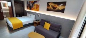 a small room with a bed and a couch at Poseidonio in Piraeus