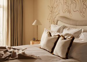 a bedroom with a bed with white sheets and pillows at No 42 by GuestHouse, Margate in Margate