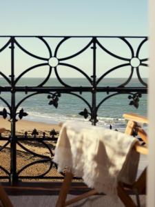 a table and chairs with a view of the beach at No 42 by GuestHouse, Margate in Margate