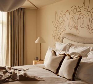 a bedroom with a bed with a painting on the wall at No 42 by GuestHouse, Margate in Margate