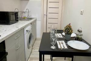 a small kitchen with a table with a microwave at Studio 2 MEGA MALL National Arena in Bucharest