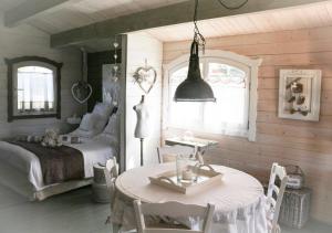 a bedroom with a bed and a table and chairs at Chalet de Charme in Aniane