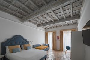 ein Schlafzimmer mit einem großen Bett und einem blauen Kopfteil in der Unterkunft Palazzo Lupardi Relais in Rom