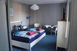 a bedroom with a bed and a television in it at Pension Lotte in Kühlungsborn