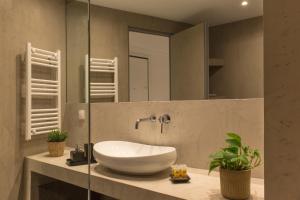 a bathroom with a white sink and a mirror at Luxury Apt with Parking-Living Stone Silver in Athens +31 photos
