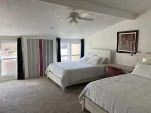 a bedroom with two beds and a ceiling fan at Large Bedroom With 2 Queen Bed in Charlotte