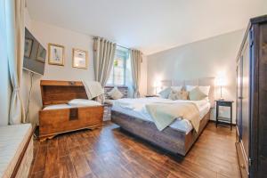 a bedroom with a large bed and a window at Apartamenty Sun & Snow Dębowa in Sopot