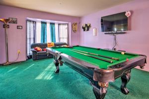 a living room with a pool table and a tv at Alexandria Area Vacation Rental with Backyard in Accokeek