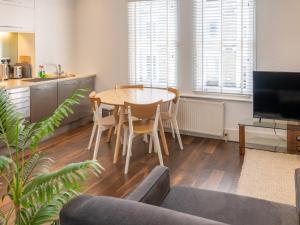 a living room with a table and a kitchen at Pass the Keys - Top Floor Flat in the heart of Portobello Market, London in London
