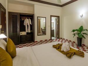 a room with a bed with towels on the floor at Chateau d'Angkor La Residence in Siem Reap